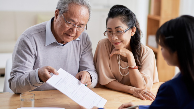 A couple looking at an estate plan with their investment advisor